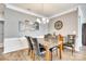 Elegant dining room with hardwood floors, crown molding, stylish chandelier, and a neutral color palette at 953 Kirby Dr, Fort Mill, SC 29715