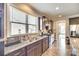 Kitchen features dark wood cabinetry, granite countertops, stainless steel appliances, and ample natural light at 953 Kirby Dr, Fort Mill, SC 29715
