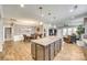 Open concept kitchen and living area with a large island, stainless appliances, and hardwood floors at 953 Kirby Dr, Fort Mill, SC 29715