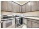 Laundry room with stainless steel washer/dryer, granite countertop, and plenty of storage at 953 Kirby Dr, Fort Mill, SC 29715
