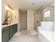 This full bathroom features a glass enclosed shower and tub with marble style shower walls and accents, plus a double vanity at 10035 Mast Cove Ln, Charlotte, NC 28278