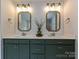 This full bathroom features double vanity sinks, a large mirror, and modern fixtures at 10035 Mast Cove Ln, Charlotte, NC 28278