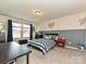 This bedroom has a large window, a neutral accent wall, and soft carpet at 10035 Mast Cove Ln, Charlotte, NC 28278