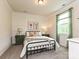 This charming bedroom has a large window, a modern accent wall, and soft carpet at 10035 Mast Cove Ln, Charlotte, NC 28278