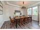Elegant dining room features chandelier, large table, and bright windows, offering an inviting atmosphere at 10035 Mast Cove Ln, Charlotte, NC 28278