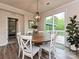 Bright dining room with a round wooden table, white chairs, and a view of the outdoor deck through sliding glass doors at 10035 Mast Cove Ln, Charlotte, NC 28278