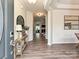 Inviting foyer featuring hardwood floors, elegant decor, and an open view into the living spaces at 10035 Mast Cove Ln, Charlotte, NC 28278