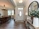 Bright foyer featuring hardwood floors, a stylish mirror, and a glimpse of the dining area at 10035 Mast Cove Ln, Charlotte, NC 28278