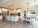 Spacious kitchen with white cabinets, stainless steel appliances, granite counters and a dining area at 10035 Mast Cove Ln, Charlotte, NC 28278