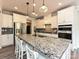 Bright kitchen featuring a granite island with bar seating, stainless appliances, and modern lighting at 10035 Mast Cove Ln, Charlotte, NC 28278