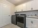 Well-equipped laundry room features modern appliances, ample cabinet space, and stylish tile accents at 10035 Mast Cove Ln, Charlotte, NC 28278