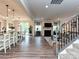 Open-concept living area with hardwood floors, a fireplace, and seamless flow between the kitchen and living spaces at 10035 Mast Cove Ln, Charlotte, NC 28278