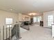 Cozy living room features plush carpeting, natural light, comfortable seating, and an airy atmosphere at 10035 Mast Cove Ln, Charlotte, NC 28278