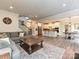 Open-concept living room flowing into the kitchen and dining areas, featuring a comfortable sectional sofa and staircase at 10035 Mast Cove Ln, Charlotte, NC 28278