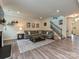 Spacious living room with a fireplace, a large sectional sofa, and a staircase leading to the upper level at 10035 Mast Cove Ln, Charlotte, NC 28278