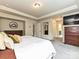 This bright primary suite features neutral walls, soft carpet, modern lighting, and a comfortable-looking king-sized bed at 10035 Mast Cove Ln, Charlotte, NC 28278