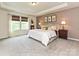 This cozy primary suite features neutral walls, soft carpet, decorative artwork, and a comfortable-looking king-sized bed at 10035 Mast Cove Ln, Charlotte, NC 28278