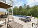 Relax on the pool patio with comfortable lounge seating under charming string lights at 10035 Mast Cove Ln, Charlotte, NC 28278