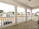 Relaxing porch offers neighborhood views, features classic columns, and plenty of room to sit back at 10035 Mast Cove Ln, Charlotte, NC 28278