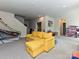 Spacious rec room with yellow sectional sofa, providing a comfortable and inviting space at 10035 Mast Cove Ln, Charlotte, NC 28278