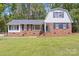 Charming brick home with a gambrel roof, well-manicured lawn, and inviting curb appeal at 101 Grier St, York, SC 29745