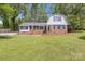 Well-kept home with a charming brick facade, white siding, and manicured lawn at 101 Grier St, York, SC 29745