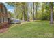 Expansive grassy backyard featuring mature trees and view of the home's exterior and deck at 101 Grier St, York, SC 29745