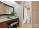 A well appointed bathroom with an ornate mirror, tiled shower, granite vanity, and decorative wreath at 101 Grier St, York, SC 29745