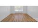 Bedroom with wood paneling, large double windows, and wood-look floors creating a warm inviting space at 101 Grier St, York, SC 29745
