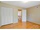 Neutral bedroom featuring closet and door; hardwood floor; off-white walls at 101 Grier St, York, SC 29745