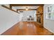 Cozy living room featuring hardwood floors, brick fireplace, and exposed beams at 101 Grier St, York, SC 29745