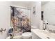 Cozy bathroom with a patterned shower curtain, a neutral tiled floor and a white vanity sink at 1131 Laurel St, Salisbury, NC 28144