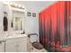 Compact bathroom features a patterned shower curtain, a white vanity, and standard fixtures at 1131 Laurel St, Salisbury, NC 28144