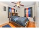 A bedroom featuring wood floors, a ceiling fan and colorful drapes for a cozy and vibrant atmosphere at 1131 Laurel St, Salisbury, NC 28144
