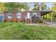 Charming brick home featuring a welcoming front porch and a convenient covered carport, all set on a lush lot at 1131 Laurel St, Salisbury, NC 28144
