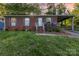 Charming brick home featuring a welcoming front porch and a convenient covered carport, all set on a lush lot at 1131 Laurel St, Salisbury, NC 28144