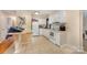 Well-lit kitchen featuring white appliances, tiled floors, ample counter space, and white cabinets, ready for culinary adventures at 1131 Laurel St, Salisbury, NC 28144