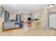 Bright, open living area with hardwood and tile flooring, featuring a comfortable sofa and a view of the kitchen at 1131 Laurel St, Salisbury, NC 28144
