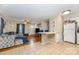 Open-concept living area with hardwood and tile flooring, a comfortable sofa, and seamless flow into the kitchen at 1131 Laurel St, Salisbury, NC 28144