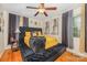 Luxurious main bedroom with a tufted headboard, wood floors, and warm lighting, creating a relaxing retreat at 1131 Laurel St, Salisbury, NC 28144
