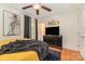 The main bedroom has hardwood flooring, soft neutral walls, lots of light and a large dresser with tv at 1131 Laurel St, Salisbury, NC 28144