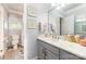 Bright bathroom featuring custom mirror, marbled vanity, and tile floors at 114 Misty Meadows Ct, Mooresville, NC 28117