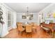 Spacious dining room with hardwood floors, lots of natural light, and seating for six at 114 Misty Meadows Ct, Mooresville, NC 28117