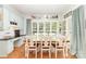 Charming dining room featuring large windows, hardwood floors, and a stylish chandelier at 114 Misty Meadows Ct, Mooresville, NC 28117