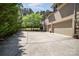 Spacious driveway leading to a three-car garage and a basketball hoop and court at 114 Misty Meadows Ct, Mooresville, NC 28117