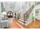 Grand foyer boasts hardwood floors, soaring ceilings, and an elegant staircase with iron railings at 114 Misty Meadows Ct, Mooresville, NC 28117