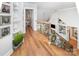 Hallway with hardwood floors, wrought iron railing and view of the living room at 114 Misty Meadows Ct, Mooresville, NC 28117