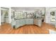 Open kitchen with granite counters, stainless appliances, tile backsplash, and hardwood floors at 114 Misty Meadows Ct, Mooresville, NC 28117