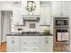 Modern kitchen with white cabinetry, black countertop, and stainless steel appliances at 114 Misty Meadows Ct, Mooresville, NC 28117