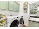 Efficient laundry room offers a washer, dryer, and lots of storage space at 114 Misty Meadows Ct, Mooresville, NC 28117